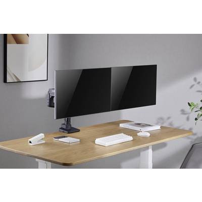 Two large monitors on a modern desk; next to them a keyboard, mouse, smartphone, book and a notepad.