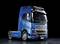 A blue lorry with the inscription 'FH16' is positioned against a black background. It is a modern, aerodynamic model.