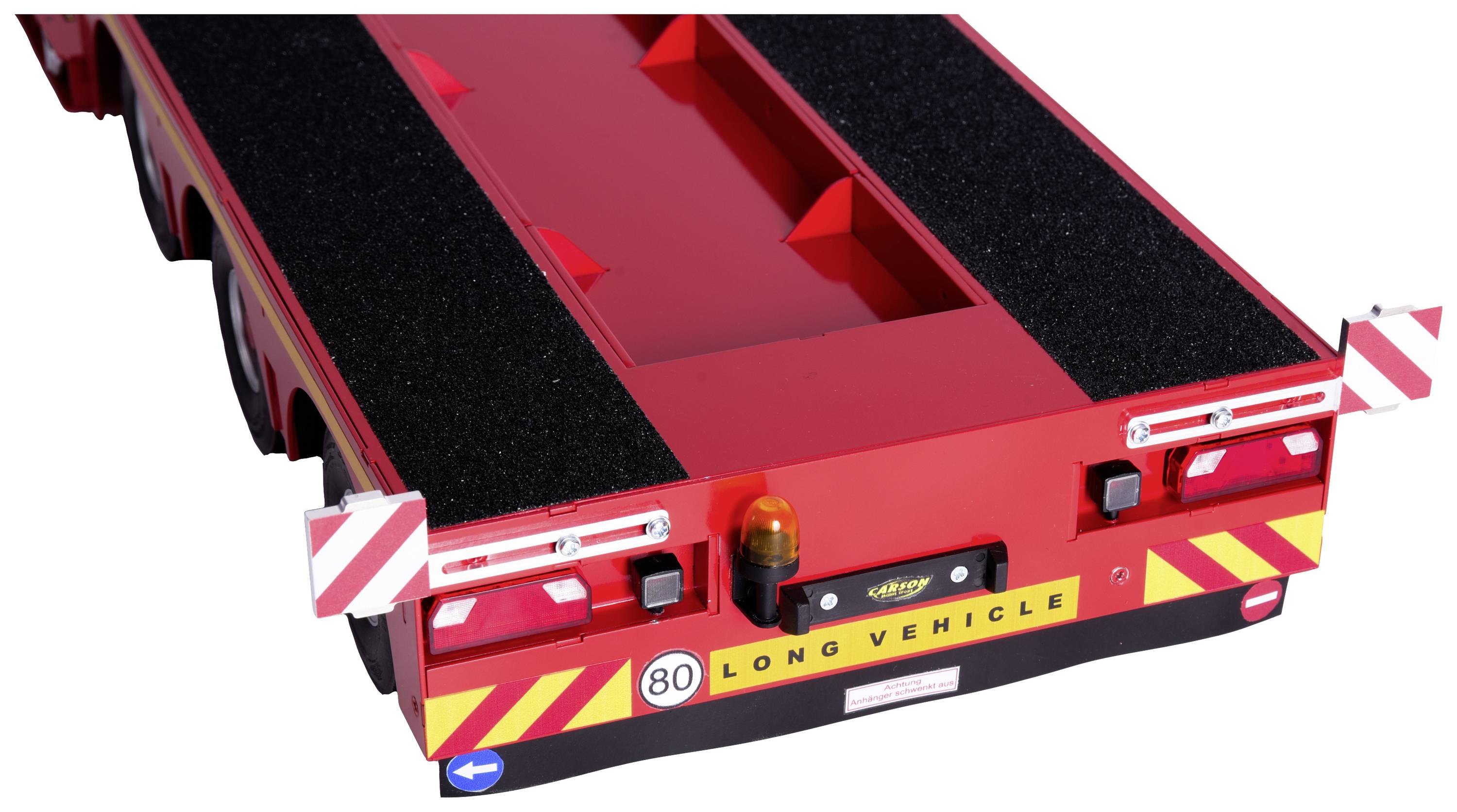 Red transport trailer with 'LONG VEHICLE' signage, safety markings and rear lights, part of a large vehicle convoy.