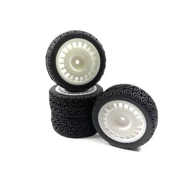 Five black model tyres with white rims, one standing upright, the others stacked beside it, against a white background.