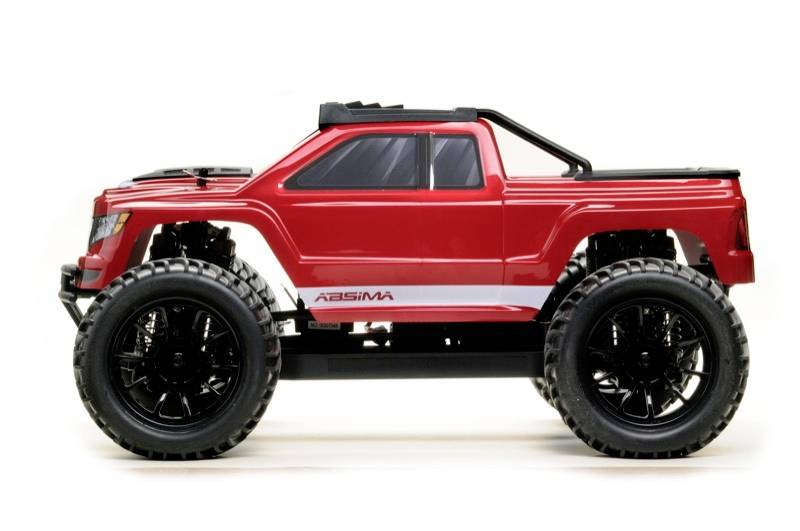 Red toy monster truck with large black tyres, side view. Suitable for children or collectors.