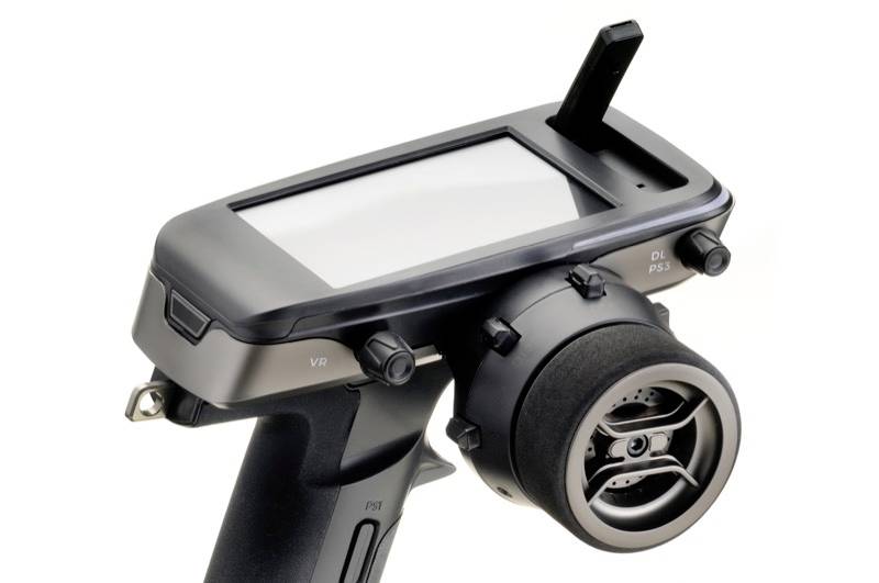 A black, handheld remote control with a large screen and multiple buttons, suitable for controlling models.