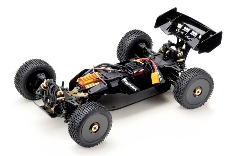 Remote-controlled model car without bodywork, showing motor, chassis and electronic components. Tyres are heavily treaded for off-road use.