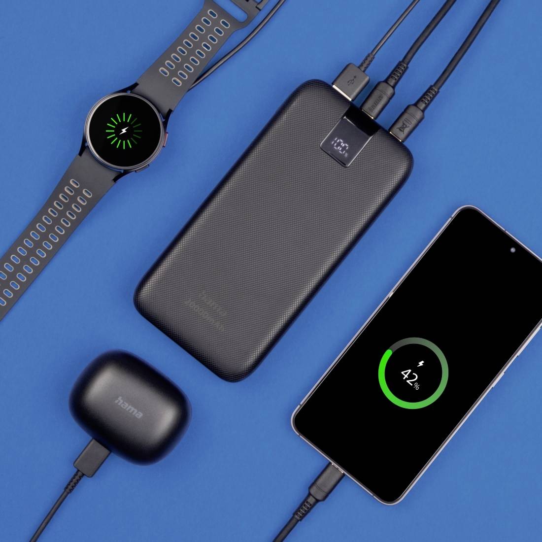 A smartwatch, a portable battery pack, a smartphone with 42% battery, and wireless earbuds against a blue background show a charging situation.