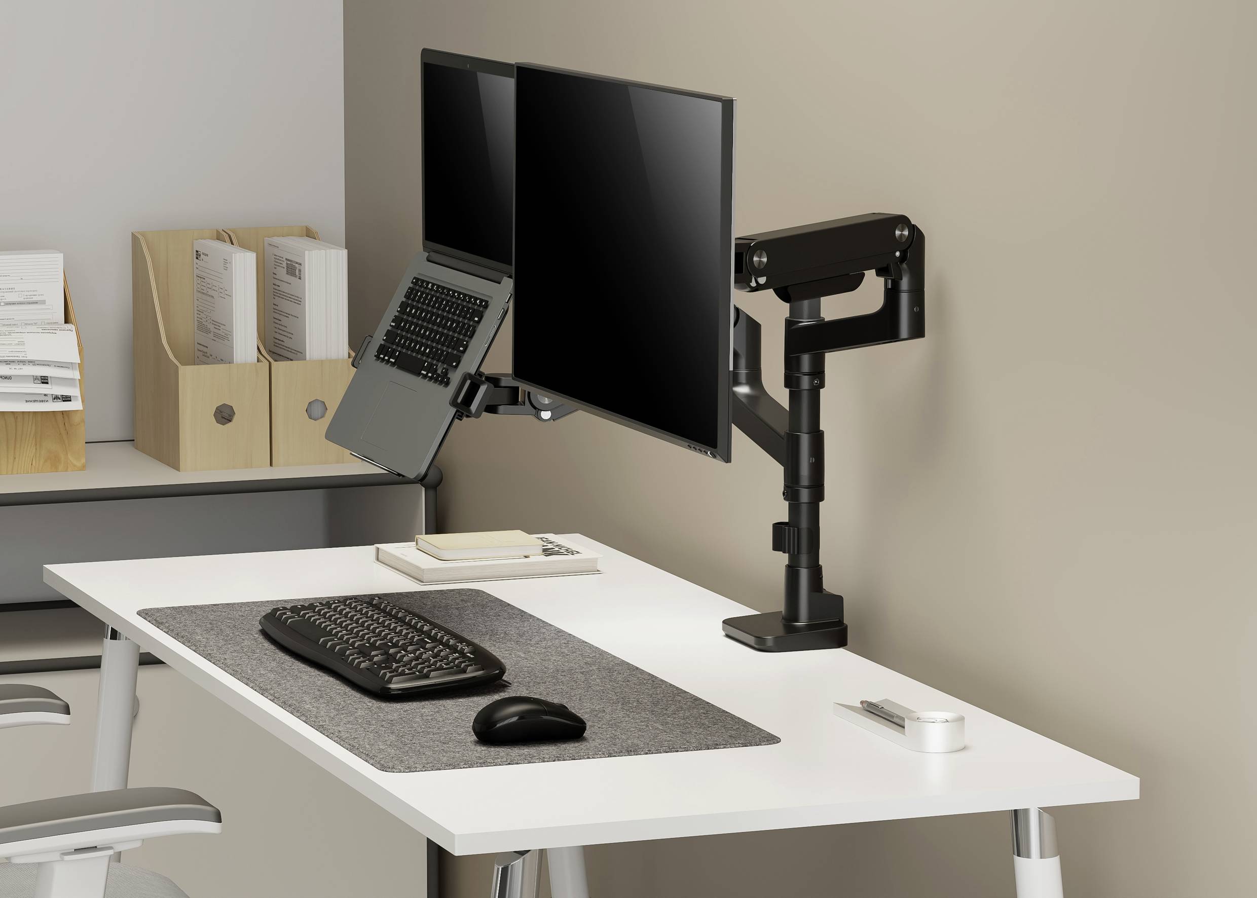 A tidy desk with two monitors and a laptop on stands. Keyboard and mouse are on the desk. File folders in the background.
