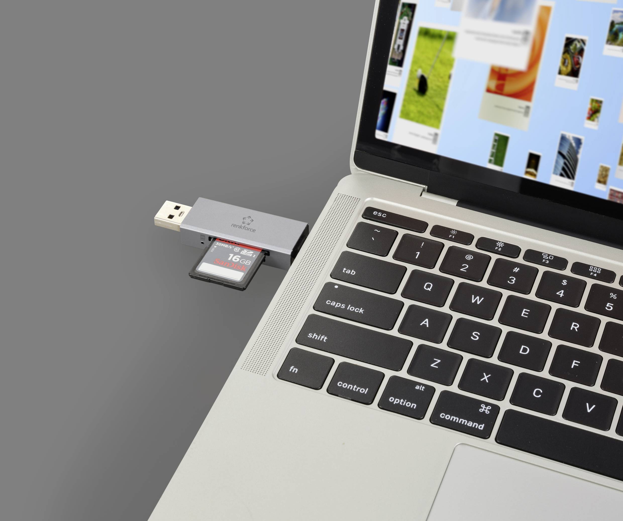 A laptop with its lid open shows a USB stick plugged in and an SD card visible in the card reader.