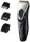 Electric hair clipper with three interchangeable attachments, suitable for various cutting lengths, in black and silver.