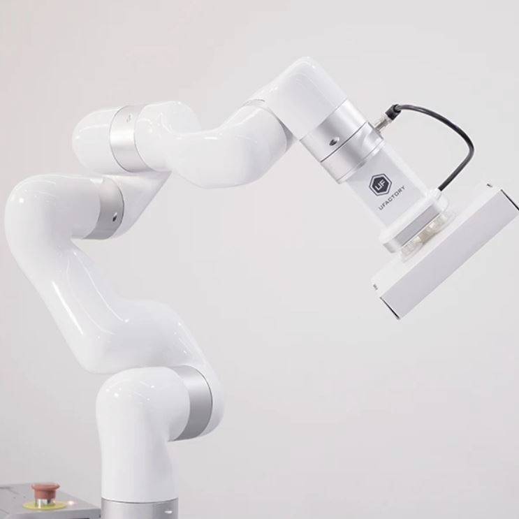 Robotic arm in white design, flexibly movable across multiple axes, demonstrates technological advances in automation.