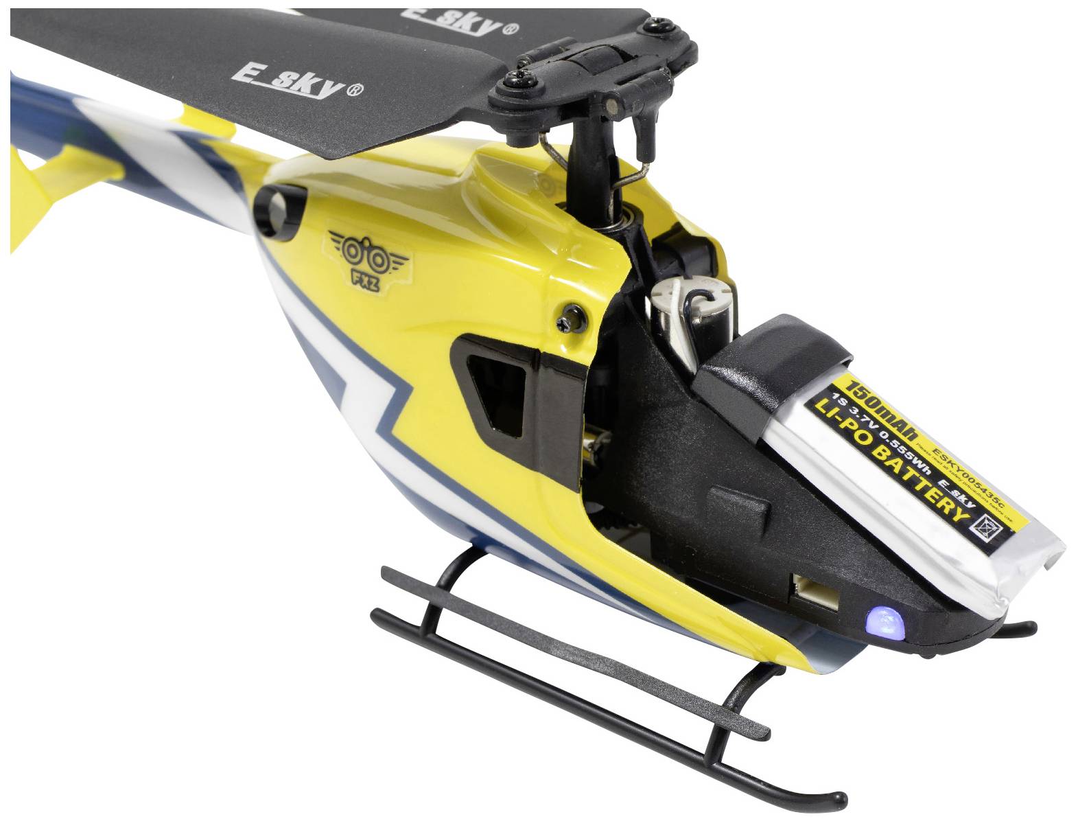 Close-up of a yellow model helicopter with black and white details and a visible battery at the front.