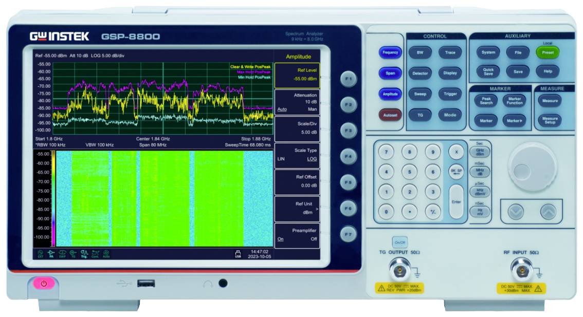 A spectrum analyser with a colour display shows two frequency diagrams. Controls and buttons are located on the right-hand side.