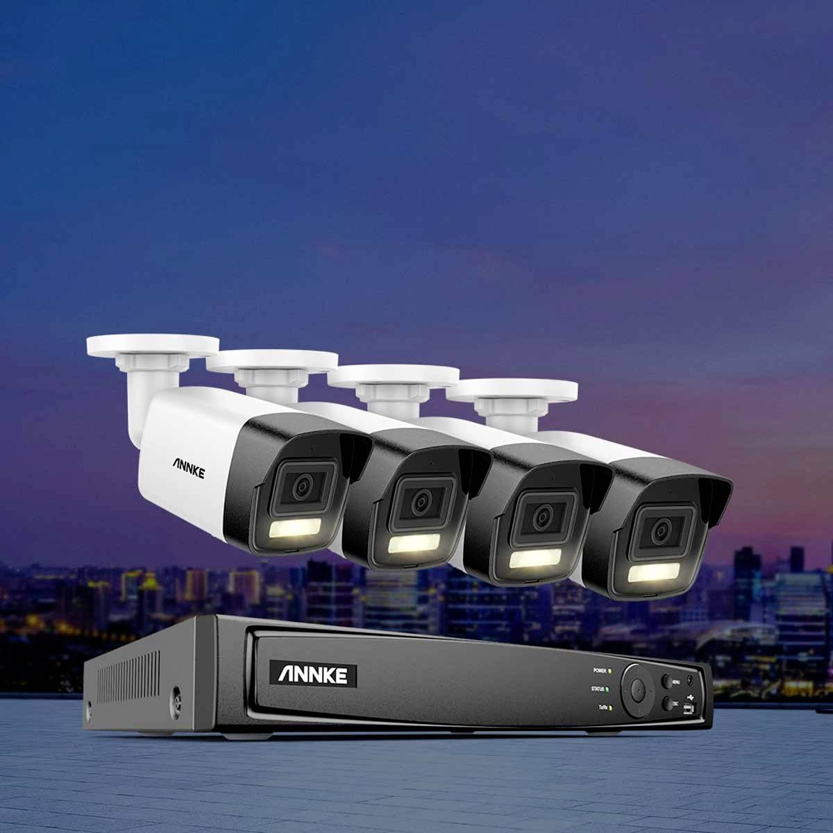 Four surveillance cameras and a recording device in front of a skyline at dusk, symbolising a security system.