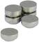 Five silver, round metal containers with perforated lids, stacked and individually placed on a white surface.