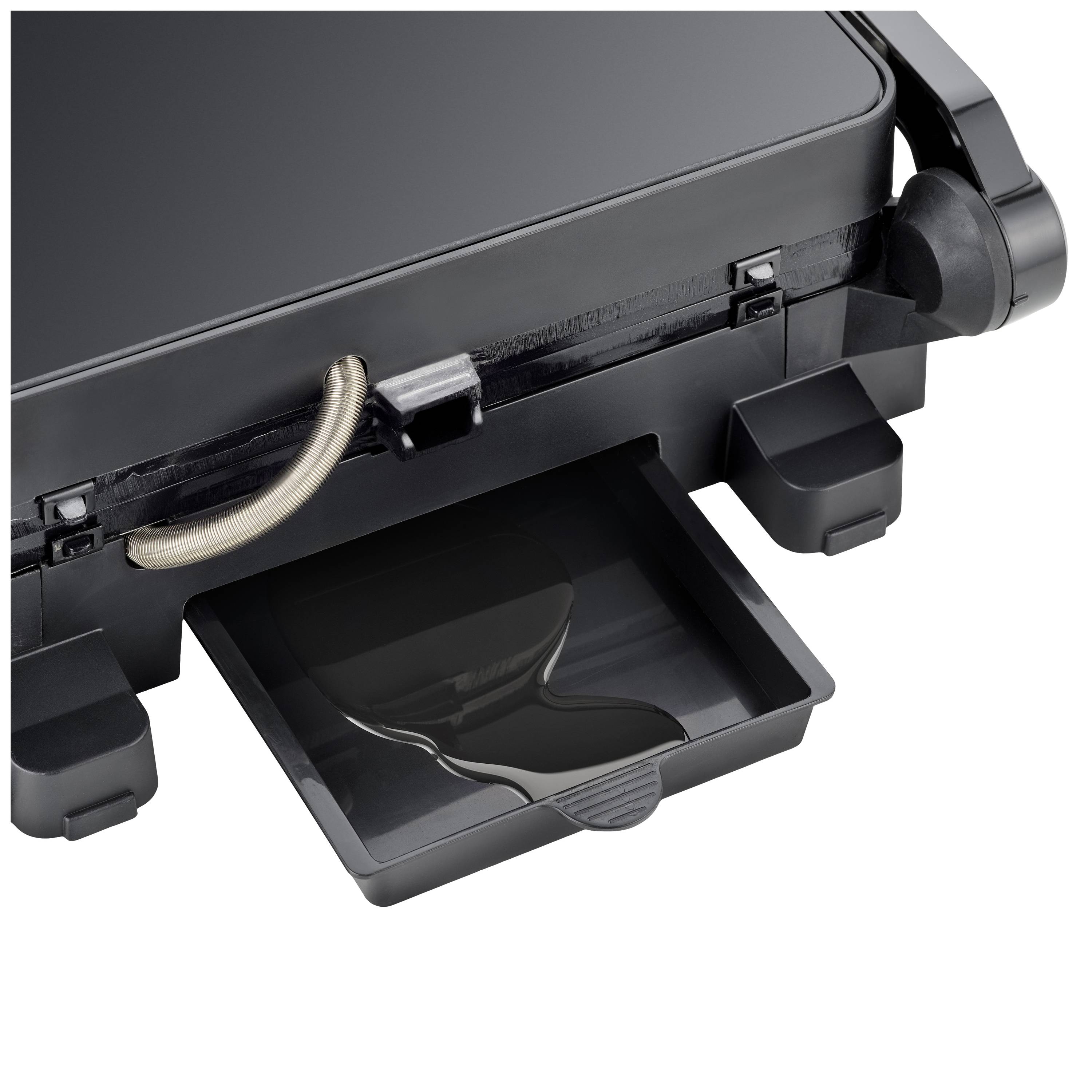 Close-up of a black waffle maker with an open collection tray for excess batter, revealing construction details.