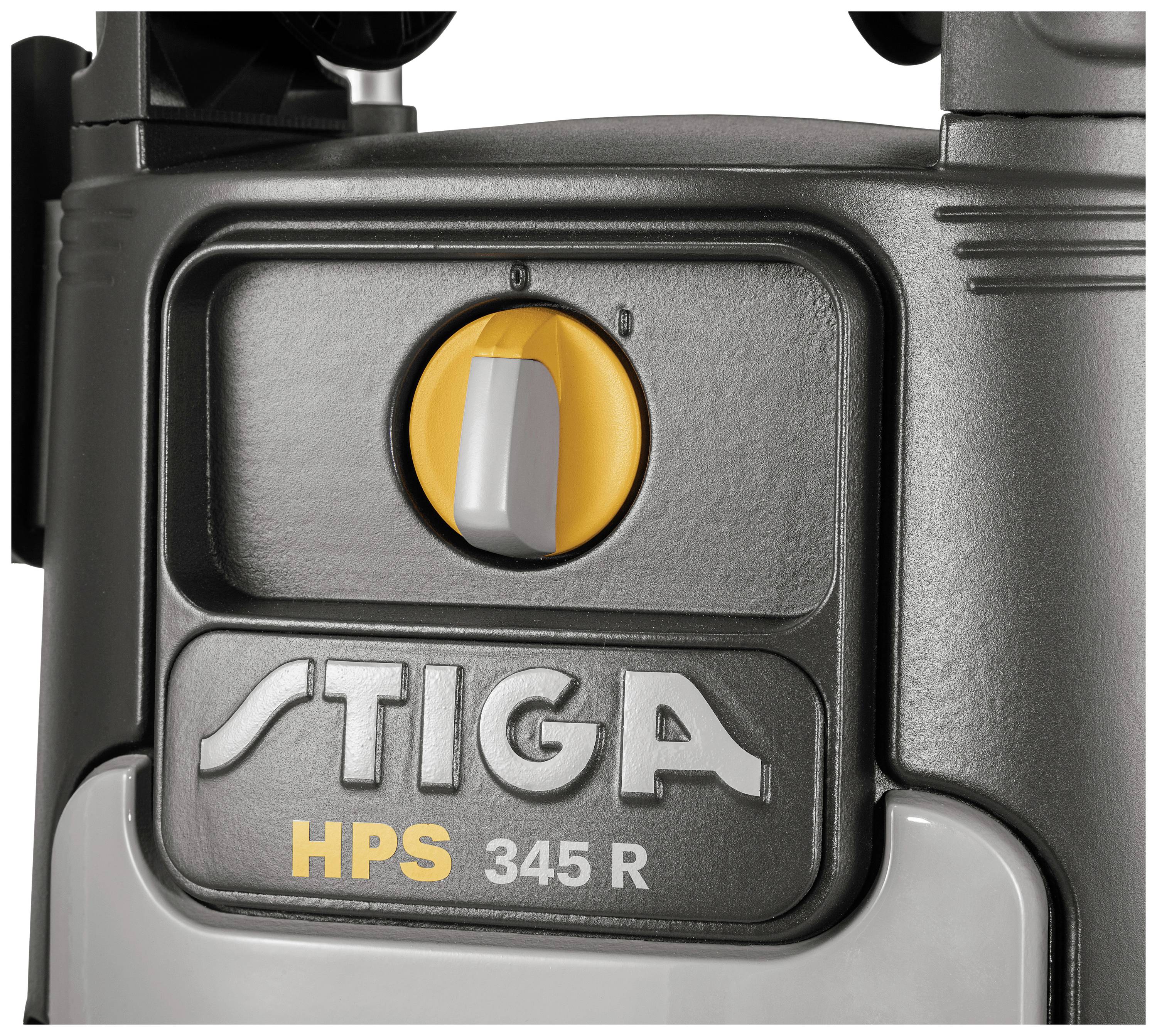 Close-up of a black device with a yellow switch on top. Underneath it reads 'STIGA HPS 345 R'.