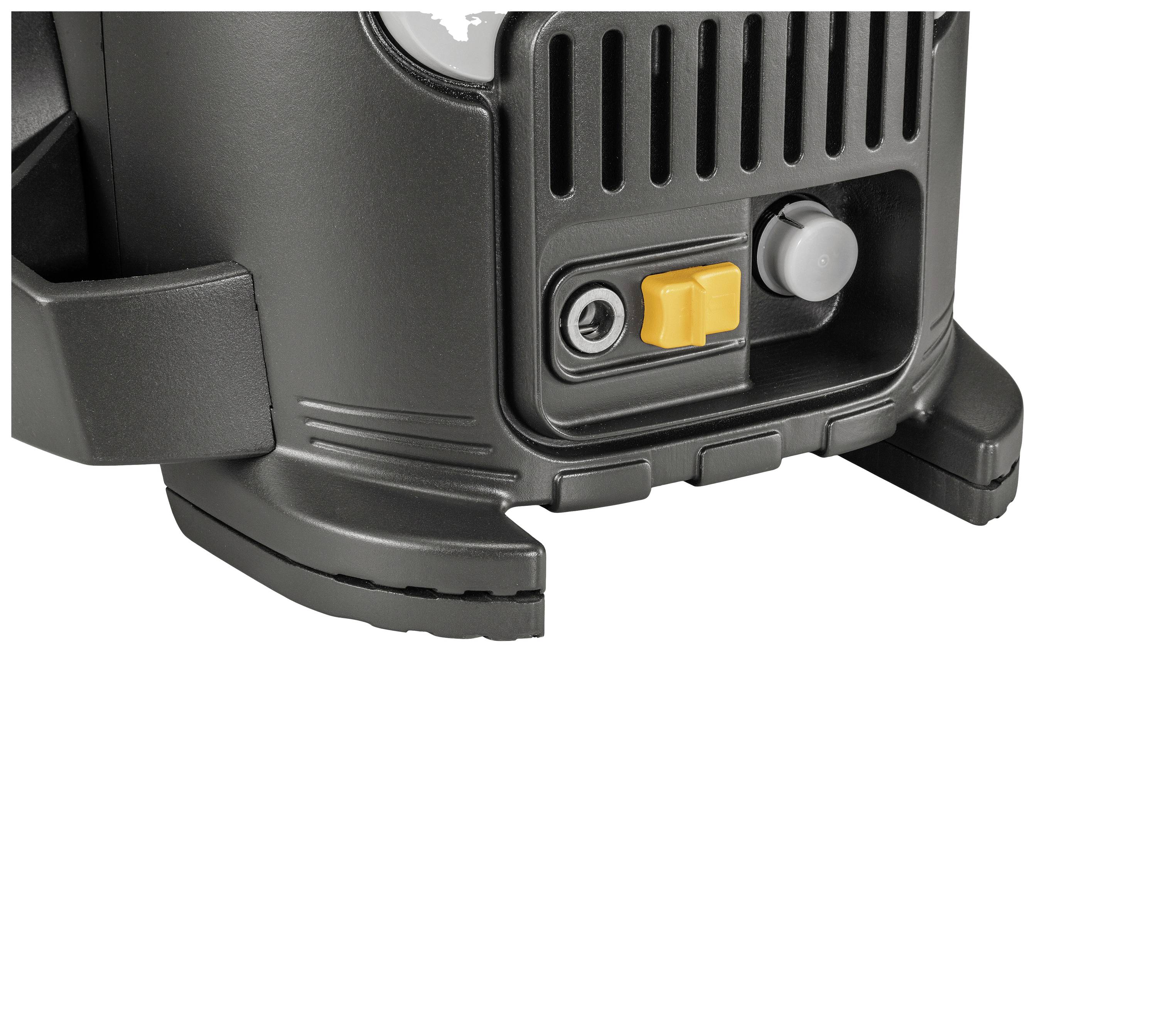 Close-up of a black device with a ribbed surface and yellow control knob, part of a larger technical apparatus.