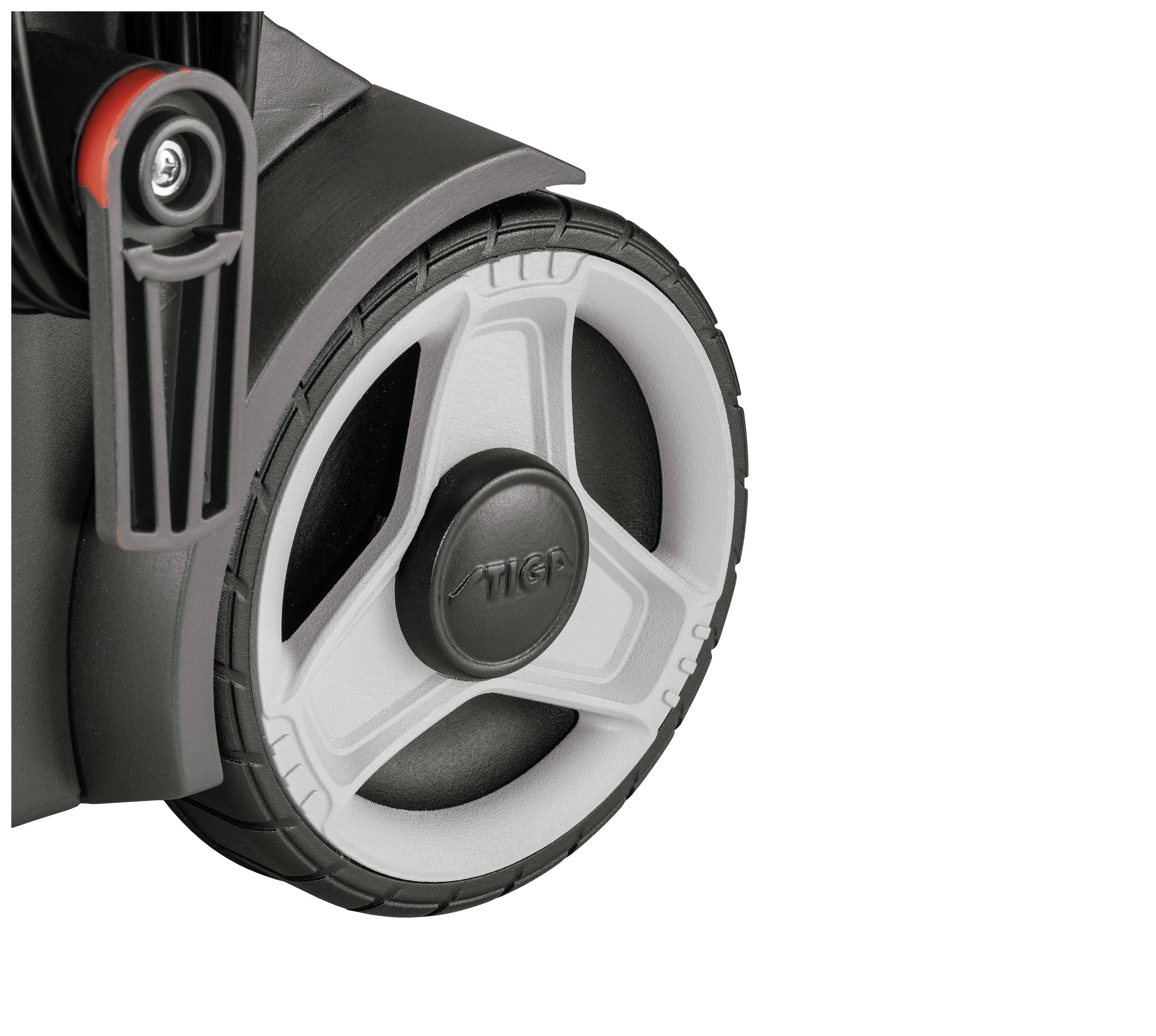 Rear view of a white plastic wheel with a black tyre on a device, possibly a lawnmower, with a grey mounting bracket.