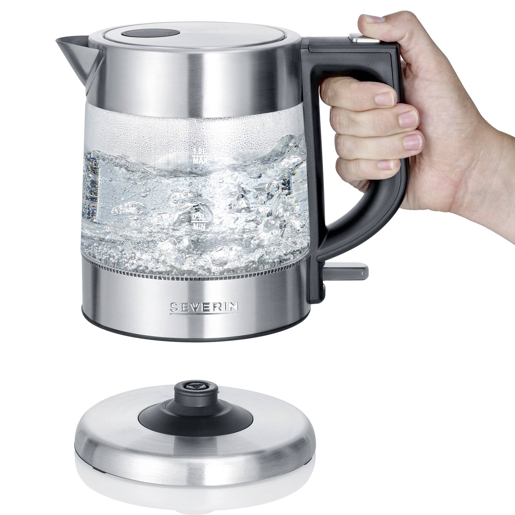 An electric kettle filled with water, held in a hand. The lid is placed separately on the worktop.