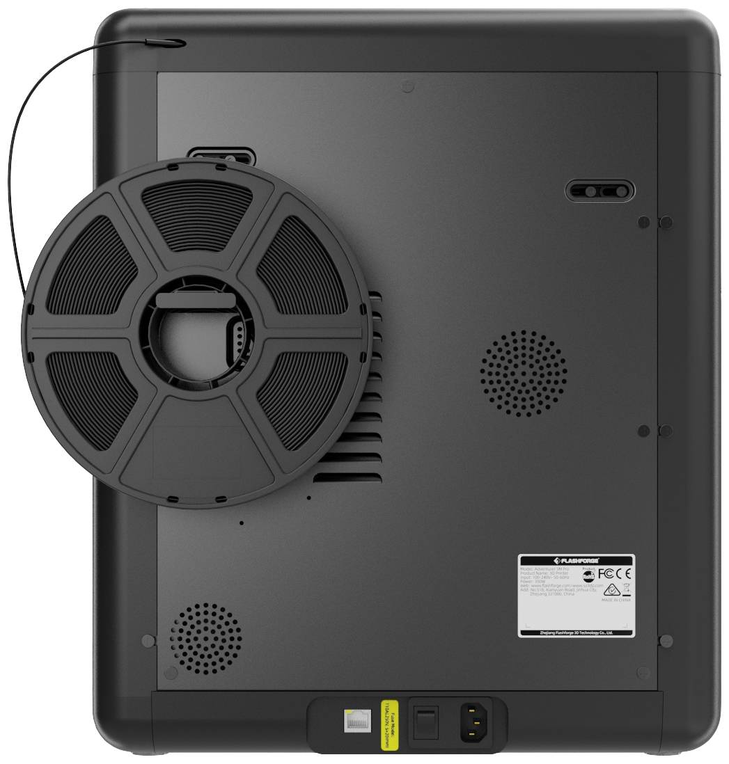 Back of a 3D printer with a filament spool, ventilation slots, and connection socket.