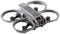 A grey drone with four propellers, compact and rounded in design, with an integrated camera system, suitable for aerial photography.