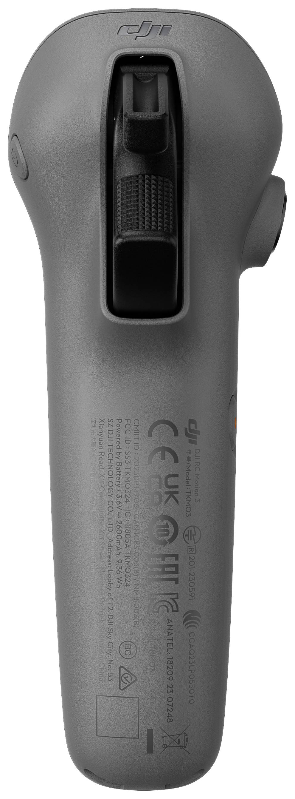 Grey remote control handle with multiple brand and certification logos on the back. Contains control elements on the top surface.