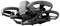 A black drone with propeller guards and a camera at the front, flying in the air.