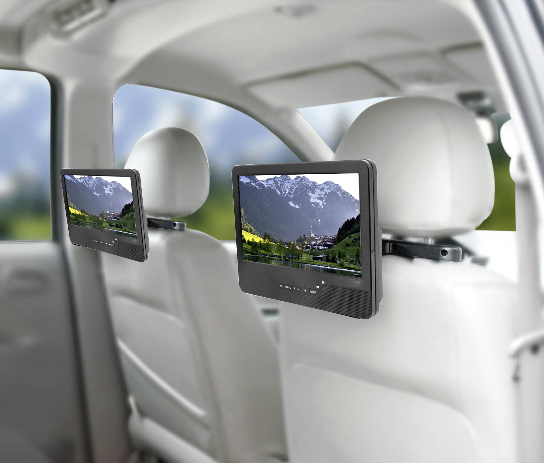 Two screens on car seats display a landscape with mountains and meadows. They serve as entertainment systems for passengers.