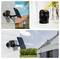 Outdoor security cameras mounted on different buildings; two with solar panels, one inside near yellow flowers.