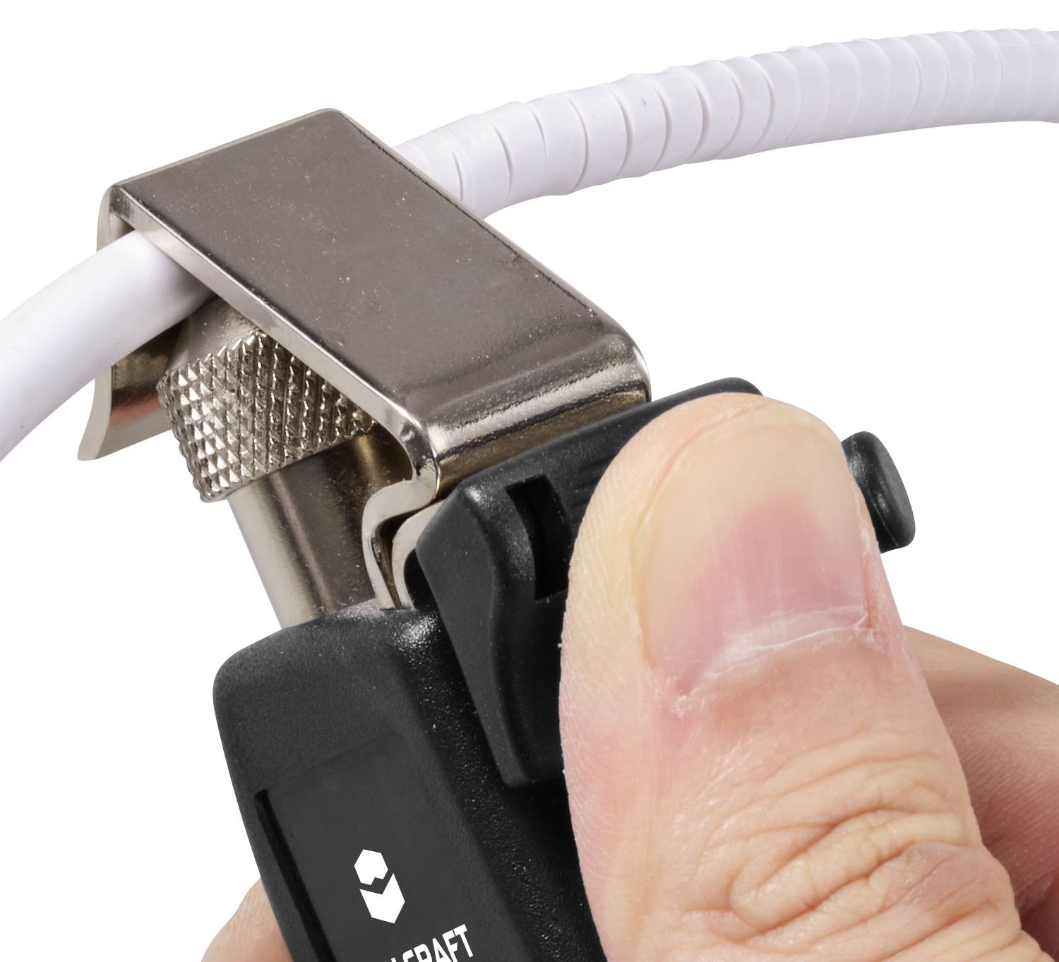 A hand is using a tool to secure a white cable in a metal clip.