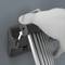 A hand is pressing a button on a device with long, parallel struts. An arrow points to the spot being pressed.