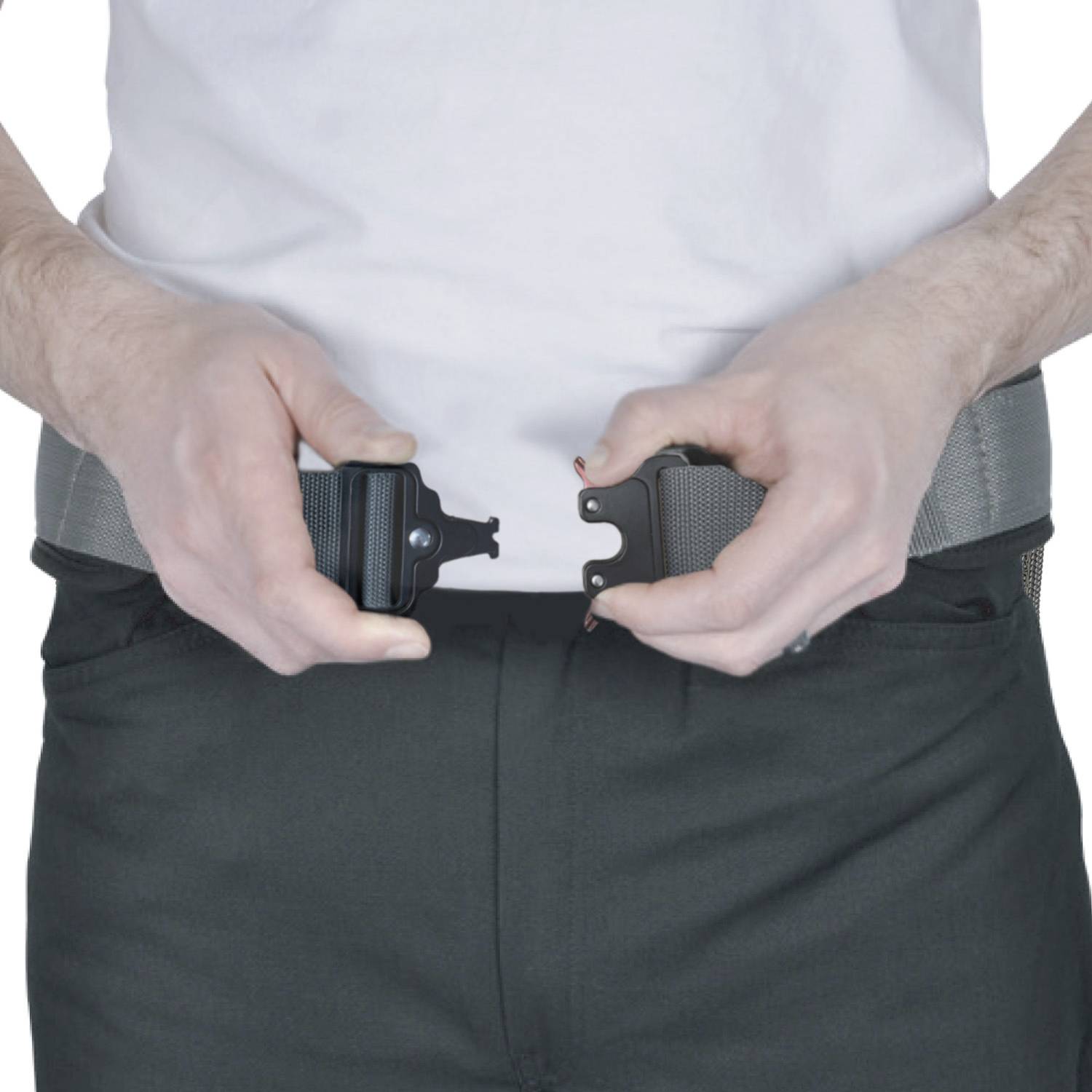 A person is holding a belt at both ends, ready to snap it together. The belt is grey, and the clothing is white and black.