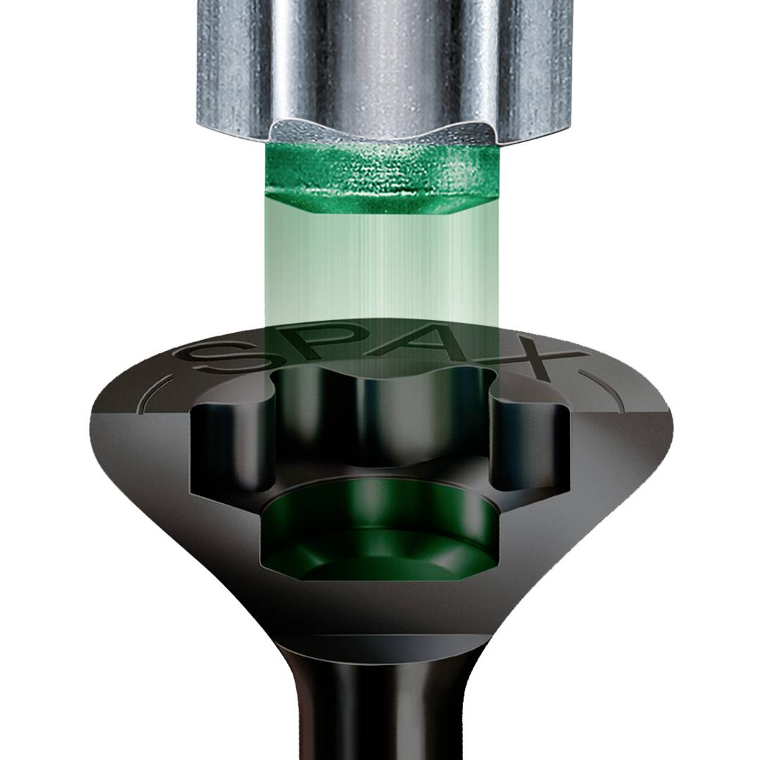 Close-up of a screw head and screwdriver. The screwdriver fits perfectly into the star-shaped head of the screw.