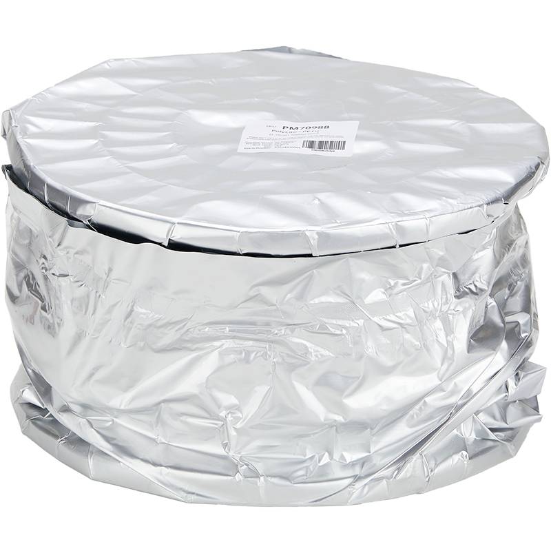An aluminium foil is wrapped around a large round container, with a label on top bearing illegible text.