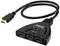 HDMI Splitter with three inputs and one output, black cable. Button for selecting the input, compact design.