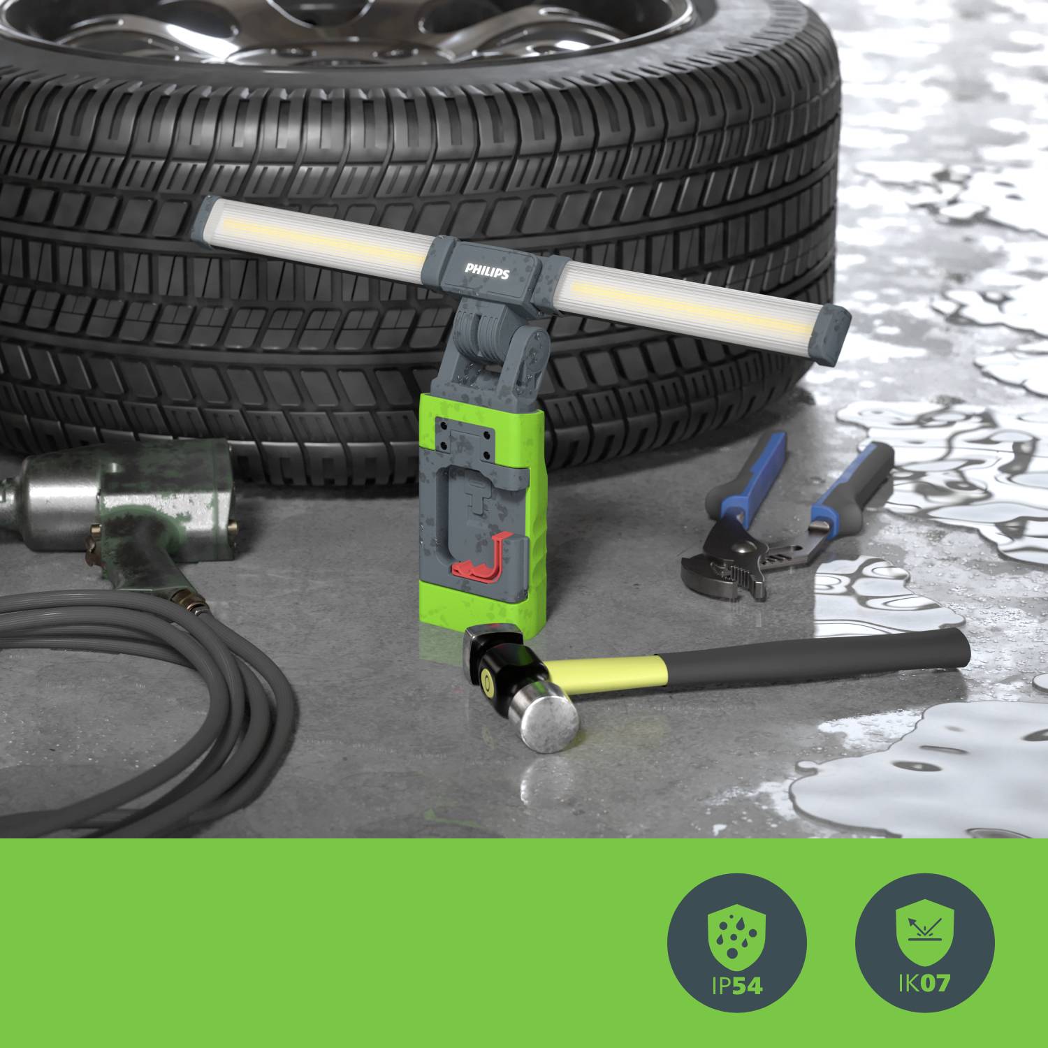 'Tools and tyres in a garage, with focus on a portable LED lamp in the foreground.'