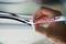 A hand is holding a white marker and marking a black cable. The marker is labelled 'edding 8046'.