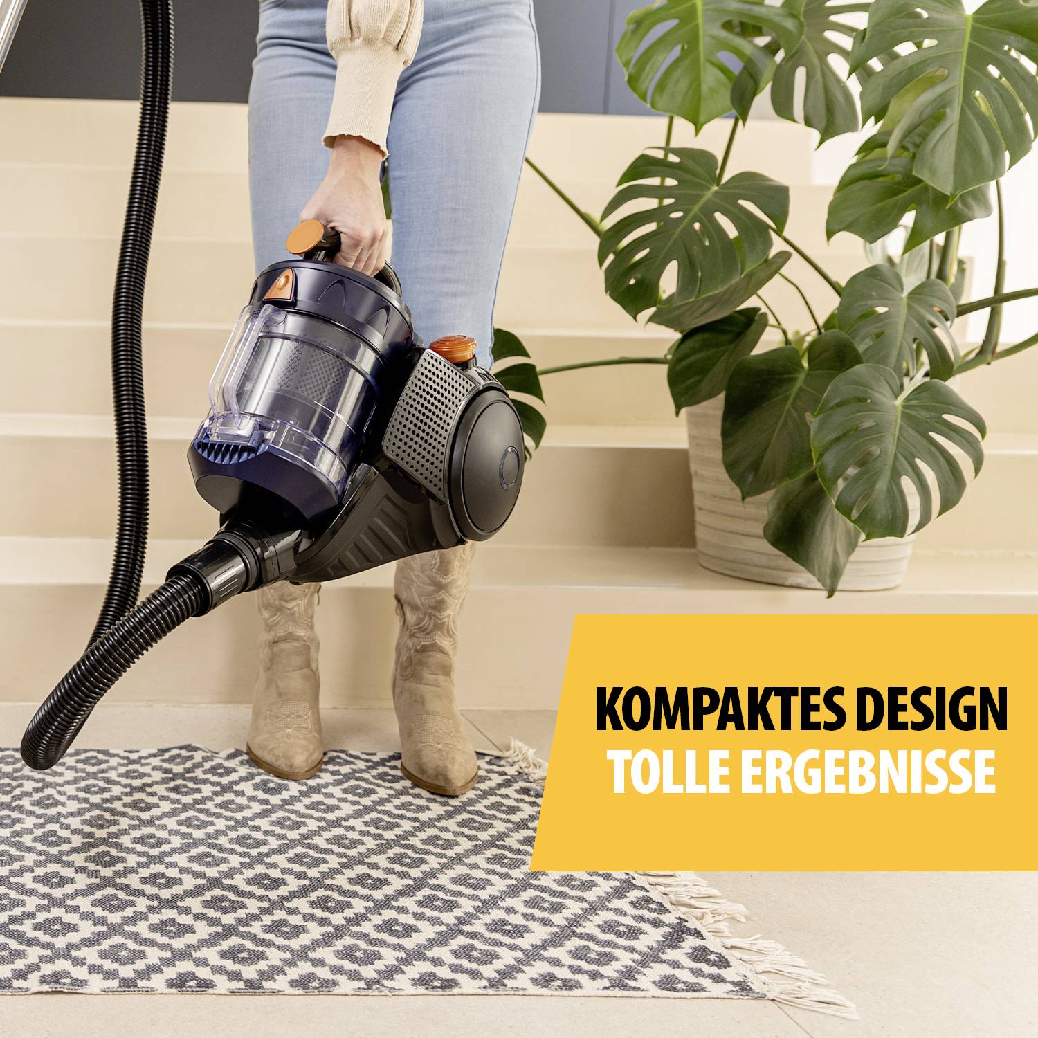 A person is hoovering a patterned carpet. A plant stands to the right. A yellow banner reads: 'Compact design, brilliant results'.