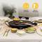 A table with laid plates, cutlery, dips and snack bowls surrounds an electric grill plate with vegetables. Suitable for 4-6 people.