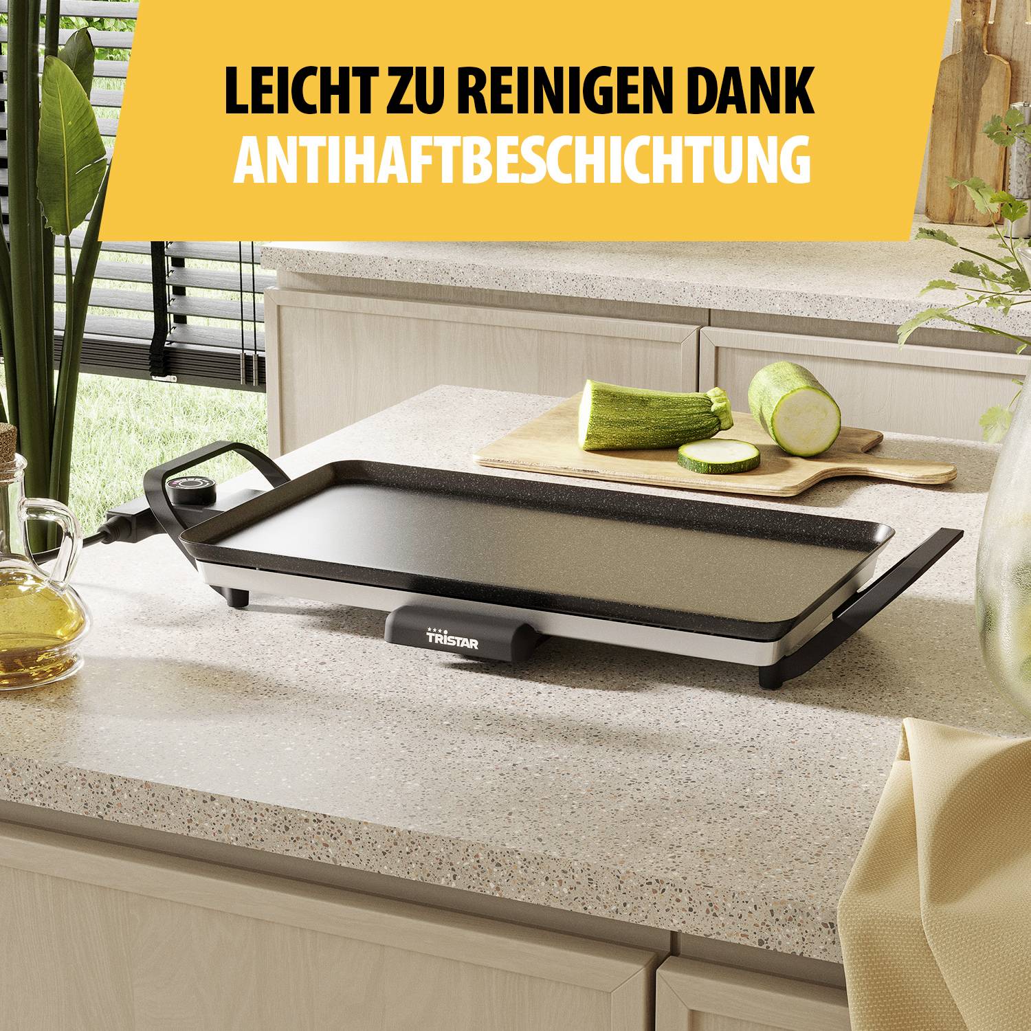 A griddle on a worktop in a kitchen. Above it reads: 'Easy to clean thanks to non-stick coating'.
