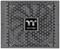 Grey and black Thermaltake computer power supply with a fan grille. Brand logo in the centre.