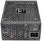 A black computer power supply unit with a fan grille on top and a power switch and power socket on the side.