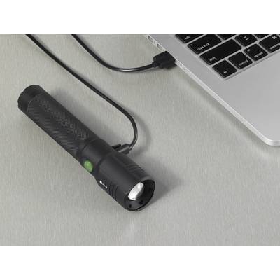 A torch is connected to a laptop via a USB cable. It appears to be lying close to the keyboard.