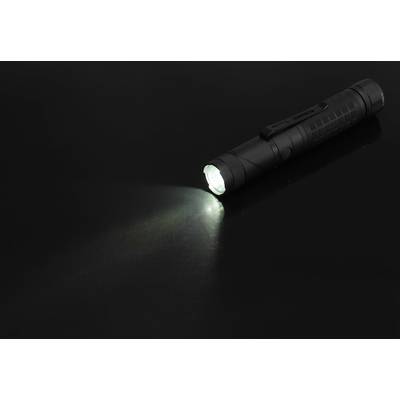 Black torch shines a bright beam of light forward in a dark environment.