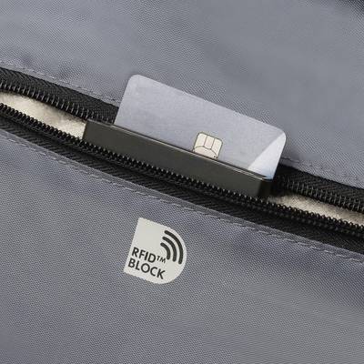 A credit card is stored in a grey zipped compartment with an RFID-blocking sticker to protect data from unauthorised reading.