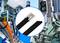 Industrial Images: Factory, Traffic Light, Cables, Security Cameras. Focus on metal band with clip in the centre. Symbolises infrastructure and technology.