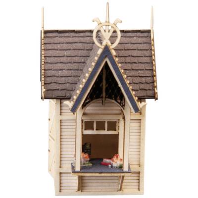 Small wooden model of a house with a steep roof and open windows. Intricately decorated and left in its natural colouring.