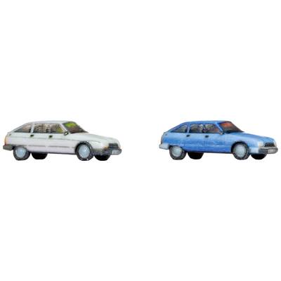 Two toy cars, one white on the left, one blue on the right, are positioned side by side. Both are slightly worn and stylised.