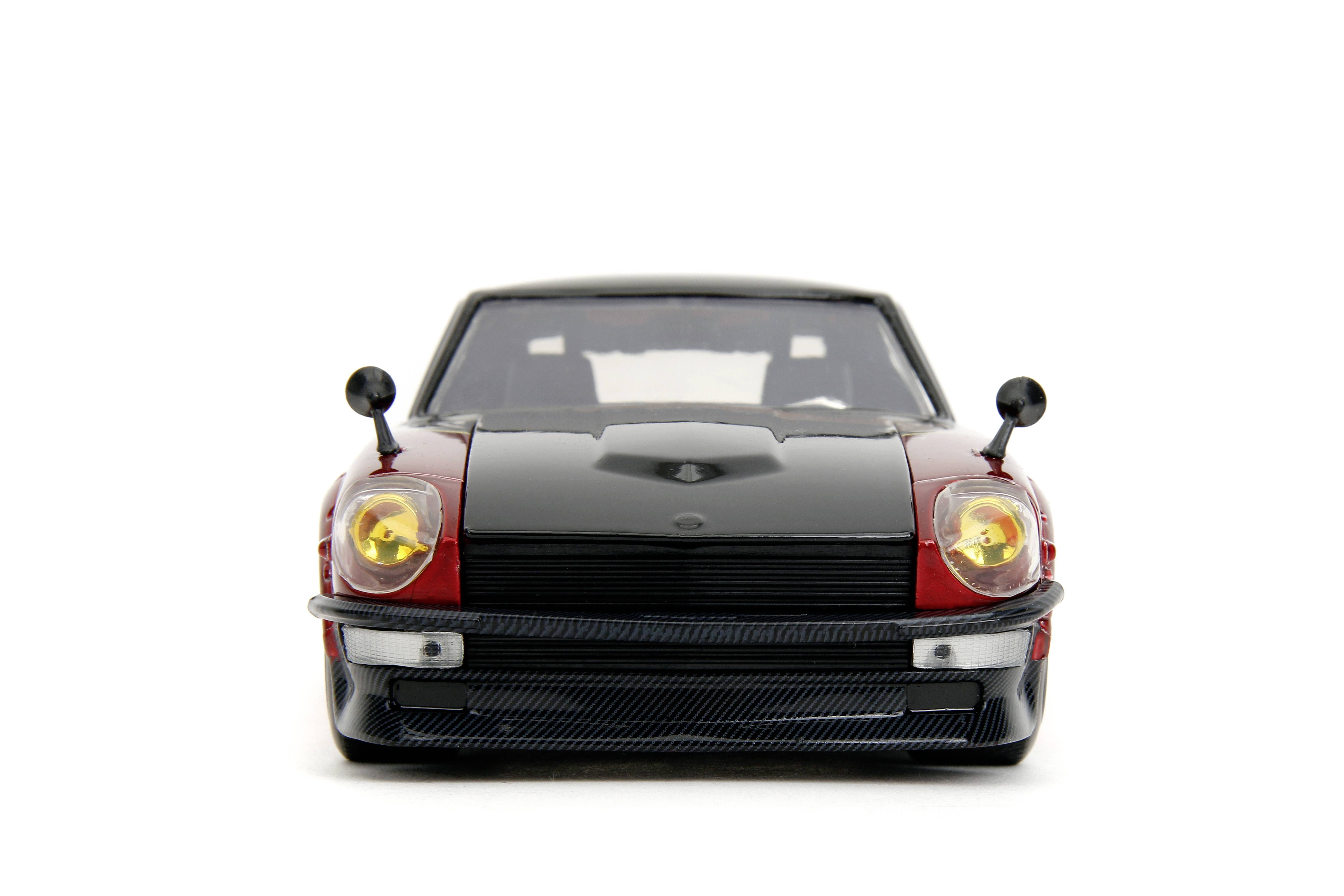 Black and red sports car model from the front on a white background. Vehicle with yellow headlights and aerials.