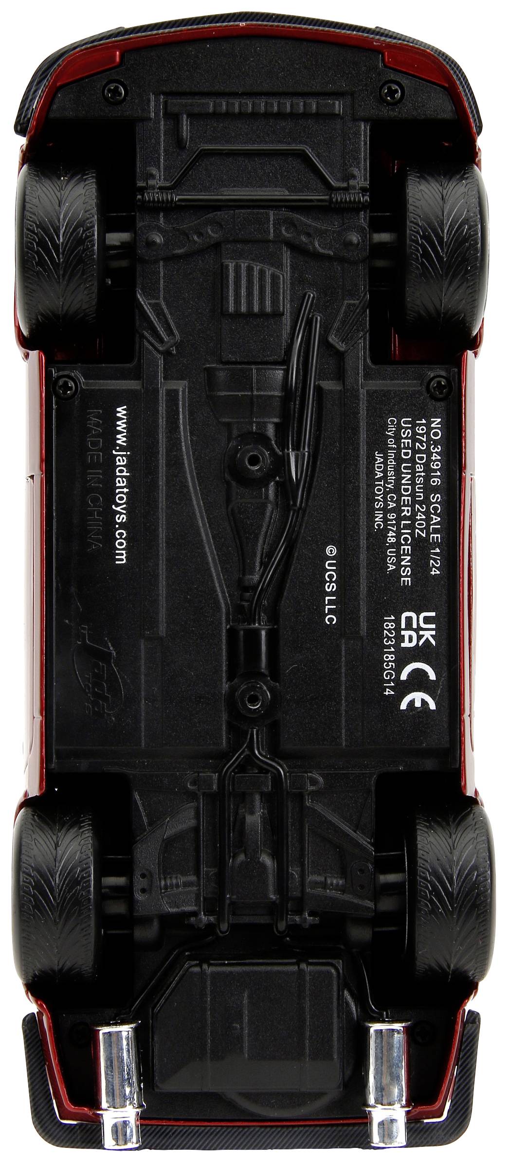 Toy car viewed from underneath, black details visible.