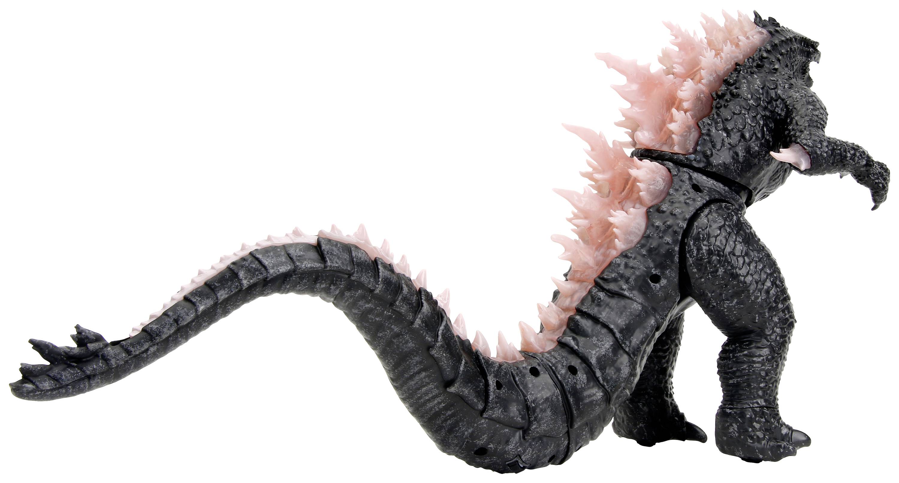 A black, monster-like toy with pink spikes along its back and long tail, stands upright.