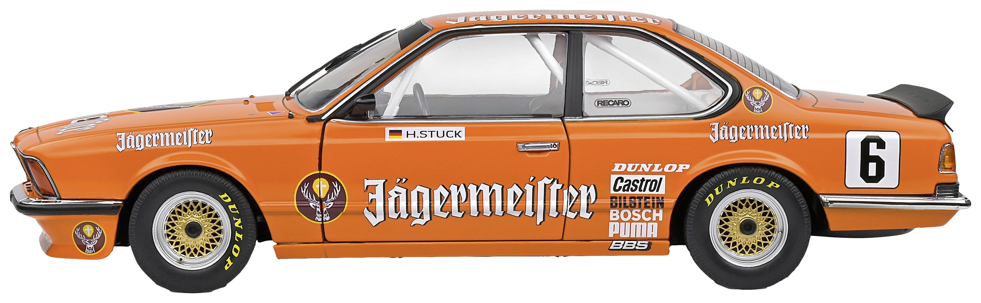An orange racing car model with 'Jägermeister' advertising and the number 6 on the side. Design by H. Stuck.